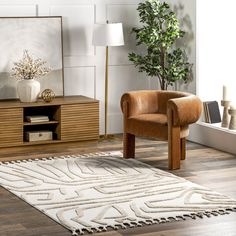 a living room with a rug, chair and potted plant on the side table