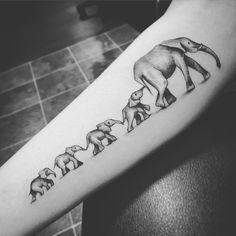 an elephant family tattoo on the arm