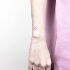 a small cloud tattoo on the left wrist