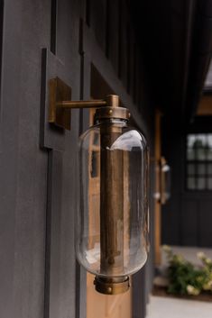 a close up of a light on the side of a building next to a door