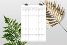 a calendar on a clipboard next to a plant