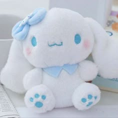 a white stuffed animal sitting on top of a table