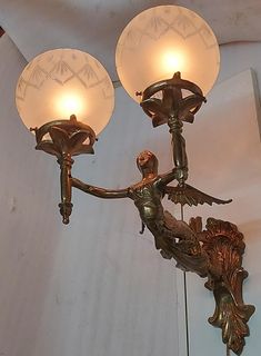 two lights that are attached to the side of a wall