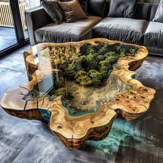 a table made out of wood and glass in the middle of a room with couches