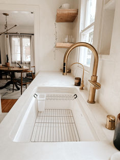 a kitchen sink with an overflowing drain running from the faucet to the counter