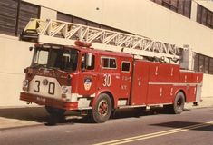 an old fire truck parked in front of a building