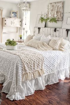 a white bed sitting on top of a wooden floor