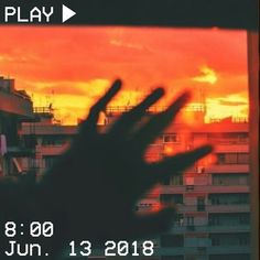 an image of someones hand in front of a sunset with the words play on it