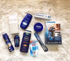 an assortment of personal care items laid out on a white carpet with the names of each product