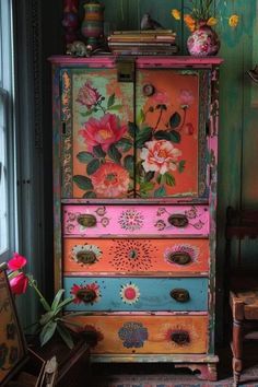 an old dresser with flowers painted on it