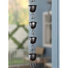 a metal candle holder hanging from the side of a door