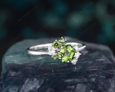 a green ring sitting on top of a rock