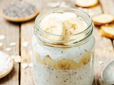 a jar filled with banana slices and chia seeds on top of a wooden table