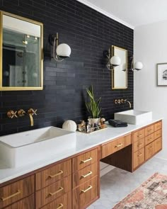 a bathroom with two sinks and mirrors on the wall