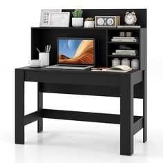 a computer desk with a laptop on top of it and bookshelf behind it