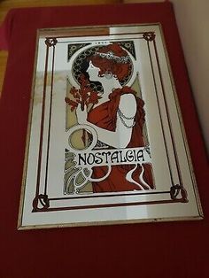 a red and white framed poster with the word nostalga on it's side