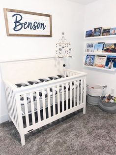 a baby's room with a crib and bookshelves on the wall