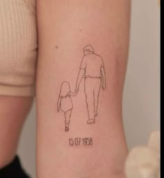 a woman's arm with a drawing of a man holding the hand of a child