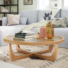 a coffee table with books and vases on it