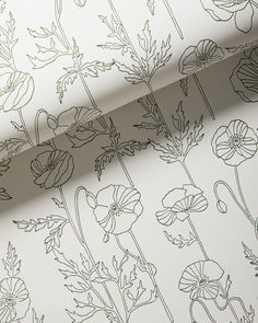 the wall paper has flowers on it and is white with green lines running through it