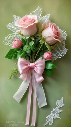 three pink roses are tied to a white lace ribbon and placed on a green background