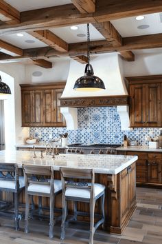 a large kitchen with wooden cabinets and white counter tops, along with blue tile backsplash