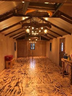 an empty room with wood flooring and lights on the ceiling is pictured in this image