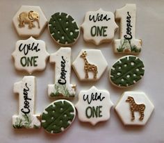 decorated cookies are arranged in the shape of animals and numbers for first birthdays or baby showers