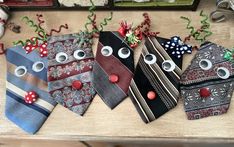 four ties with different designs on them sitting on a table