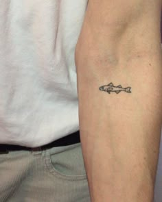 a man with a fish tattoo on his arm