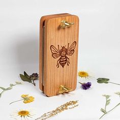 a wooden case with a bee on it