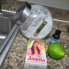 a bottle of jamila next to an orange and some other items on a counter