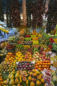 an assortment of fruits and vegetables on display at a market