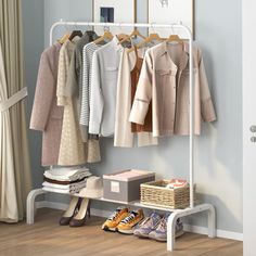 an organized closet with clothes and shoes hanging on the rack, next to a window