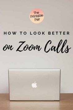 an open laptop computer sitting on top of a wooden desk with the words how to look better on zoom calls