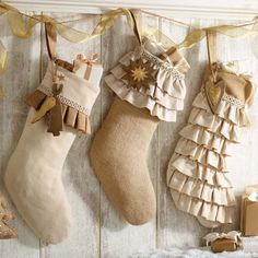 three christmas stockings hanging on the wall