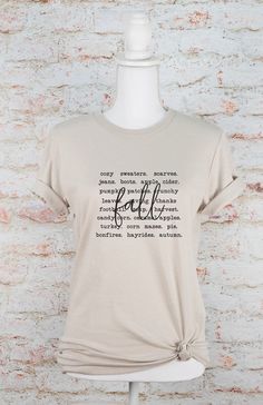 Fall Words Graphic Tee Combining comfort and style, the PLUS Fall Words Graphic Tee is the perfect addition to your wardrobe. Made with high-quality materials, this tee ensures long-lasting wear and comfort. With its trendy fall-inspired design, you'll be turning heads while expressing your love for the season. Upgrade your wardrobe with this must-have tee.100% combed and ring spun cotton Unisex Tee Comfortable Tops For Everyday Fall Wear, Comfortable Everyday Tops For Fall, Everyday Fall T-shirt With Letter Print, Trendy Soft-washed Fall Tops, Trendy Soft-washed Tops For Fall, Cotton Tops For Casual Gatherings In Fall, Everyday Cotton T-shirt For Fall, Soft-washed Casual T-shirt For Fall, Comfortable Short Sleeve Tops For Fall