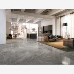 an empty living room with high ceilings and large windows