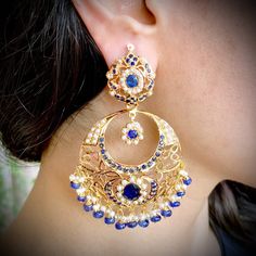 22k gold chandbali earrings with blue sapphires and pearls Blue Chandbali Chandelier Earrings For Wedding, Elegant Blue Chandbali Danglers, Heavy Blue Chandbalis For Wedding, Traditional Blue Pearl Earrings For Wedding, Elegant Blue Earrings With Tilla, Blue Chandbali Chandelier Earrings, Blue Chandbali Bridal Earrings In Temple Jewelry Style, Blue Chandbali Earrings For Wedding, Elegant Blue Kundan Chandbalis