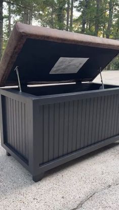 an outdoor storage box is shown with the lid open