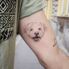 a man with a dog's face tattooed on his arm