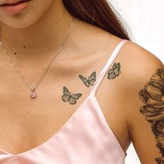 a woman wearing a pink dress with tattoos on her chest and butterfly designs on her arm