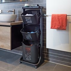 a bathroom with a sink and three baskets on the shelf