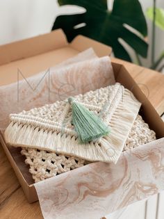 a box that has some kind of brush in it on top of a wooden table