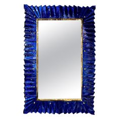 a blue mirror sitting on top of a white wall