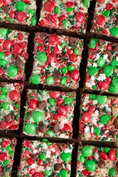 christmas brownies with candy and m & m candies on top are arranged in squares