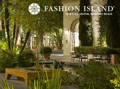 an outdoor area with tables and benches surrounded by greenery, trees and bushes at fashion island