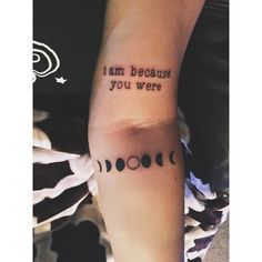 a person with a tattoo on their arm saying i am because you were the moon