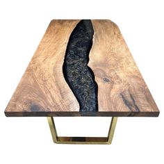 a wooden table with metal legs and a black river running through it's center