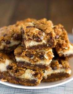 a white plate topped with chocolate chip cheesecake bars